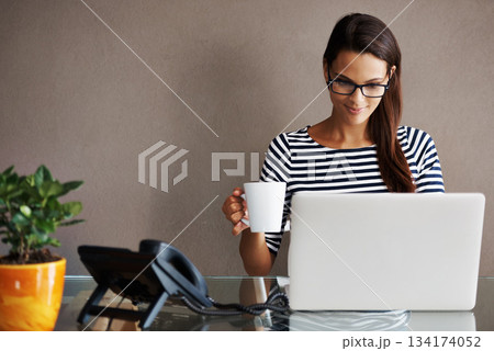 Laptop, coffee and happy business woman in office smile, satisfied and content against a wall background. Tea, research and female worker online for planning, browsing and creative inspiration Laptop, coffee and happy business woman in office smile, satisfied and content against a wall background. Tea, research and female worker online for planning, browsing and creative inspiration 134174052