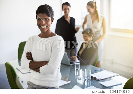 Confidence, leader and portrait of a woman in a business meeting in a modern corporate office. Happy, success and professional Indian female manager standing with crossed arms in workplace boardroom 134174056
