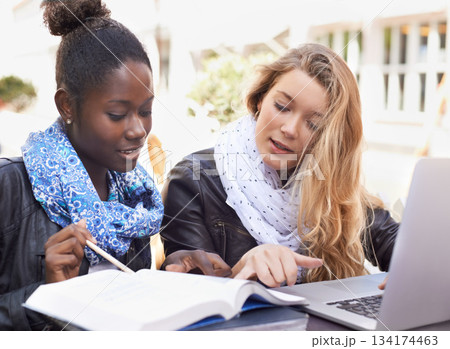 Woman, students and studying with textbook in collaboration for assignment, project or higher education in city. Women friends working together to study, ideas or work on group project in urban town Woman, students and studying with textbook in collaboration for assignment, project or higher education in city. Women friends working together to study, ideas or work on group project in urban town 134174463