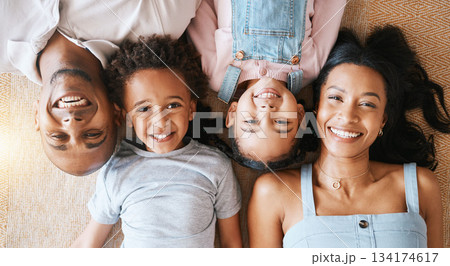 Family, portrait and top view smile in house, bonding or having fun together. Parents, happiness above and children relaxing or lying on carpet floor with man and woman, care or enjoying quality time Family, portrait and top view smile in house, bonding or having fun together. Parents, happiness above and children relaxing or lying on carpet floor with man and woman, care or enjoying quality time 134174617