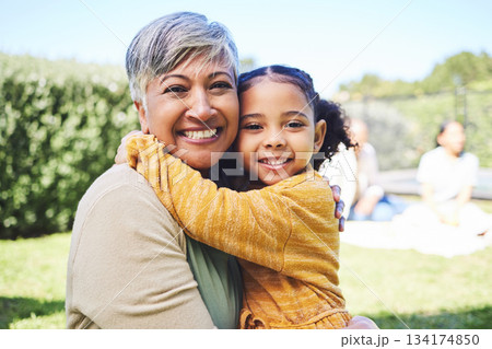 Grandmother, girl and garden portrait with hug, love and bond in summer sunshine with family. Senior woman, female child and embrace with excited face, pride and care with happiness on backyard lawn Grandmother, girl and garden portrait with hug, love and bond in summer sunshine with family. Senior woman, female child and embrace with excited face, pride and care with happiness on backyard lawn 134174850