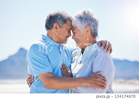 Senior couple, hug and beach love outdoor with support and romance in nature. Ocean, elderly and old woman and man together on summer holiday by the sea feeling happiness and relax on vacation 134174870
