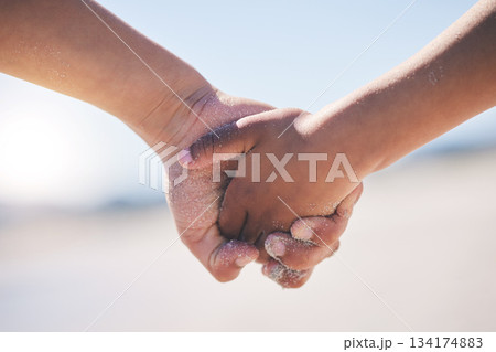 Love, unity and couple holding hands at a beach with trust, solidarity and commitment in nature. Hand, care and man with woman on romantic walk at the sea, sweet and bonding while traveling together Love, unity and couple holding hands at a beach with trust, solidarity and commitment in nature. Hand, care and man with woman on romantic walk at the sea, sweet and bonding while traveling together 134174883