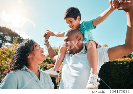 Child, father and mother outdoor as family together in backyard with a smile, love and care. Man, woman and boy kid with parents for security and quality time with happiness and support at park 134175082