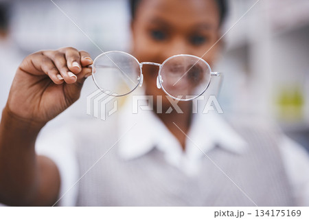 Eye care, hand and woman holding frame in clinic for health, vision and medical exam for poor sight. Eyesight, girl with designer brand glasses and lens in hand, wellness and help and focus for eyes 134175169