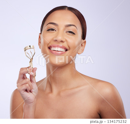 Eyelash curler, happy woman and portrait of beauty, skincare and cosmetics routine on studio background. Face of female model, smile and tools for lashes, makeup aesthetics and facial transformation 134175232
