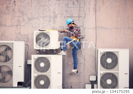 Black man, ac repair and technician, maintenance with engineering and fixing air conditioner with tools. Handyman, service and manual labor with male electrician, technology and helmet for safety 134175295