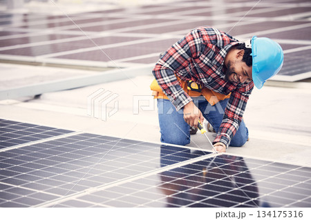 Solar panel, repair and engineering man on rooftop with tools, energy saving and sustainable power maintenance. African person, electrician contractor or technician working on photovoltaic generator 134175316