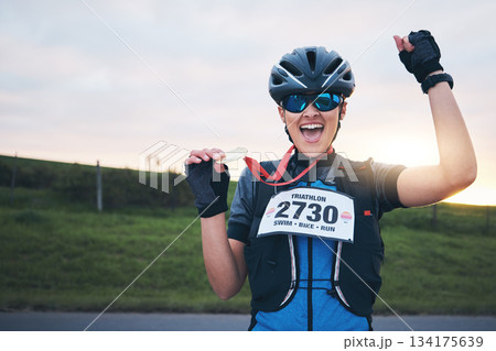 Celebrate, sport and portrait of happy woman with medal for winning outdoor cycling race or triathlon. Happiness, win and cyclist with smile, fitness and excited celebration for gold winner at sunset Celebrate, sport and portrait of happy woman with medal for winning outdoor cycling race or triathlon. Happiness, win and cyclist with smile, fitness and excited celebration for gold winner at sunset 134175639