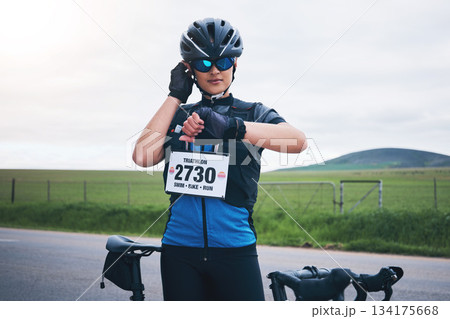 Woman outdoor, bicycle and watch to heart rate, time or speed for race, challenge or adventure. Girl, bike and check for health, fitness or gps on countryside road for cycling, contest or sport event Woman outdoor, bicycle and watch to heart rate, time or speed for race, challenge or adventure. Girl, bike and check for health, fitness or gps on countryside road for cycling, contest or sport event 134175668