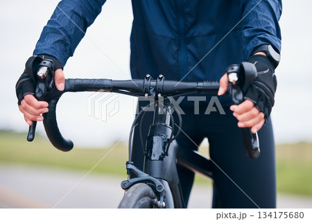 Hands of person, athlete and bicycle handlebar for training, triathlon sports and cardio fitness. Closeup, bike gear and cyclist holding lever, brakes and cycling outdoor for action, race and journey Hands of person, athlete and bicycle handlebar for training, triathlon sports and cardio fitness. Closeup, bike gear and cyclist holding lever, brakes and cycling outdoor for action, race and journey 134175680