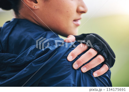 Hand closeup, shoulder pain and woman outdoor with glove for cycling, sport and fitness with emergency. Girl, nature and muscle injury at training, workout or exercise in nature with body fatigue 134175691