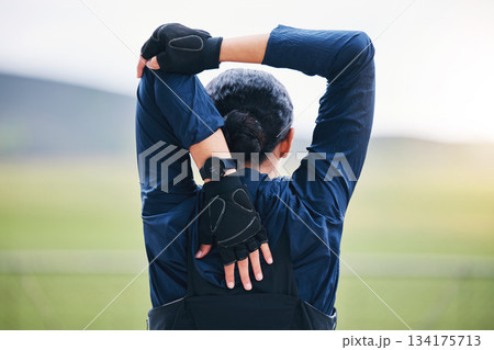 Fitness, workout and woman stretching her arms for outdoor training for a race, marathon or competition. Sports, health and back of a female athlete runner doing a warm up exercise before running. Fitness, workout and woman stretching her arms for outdoor training for a race, marathon or competition. Sports, health and back of a female athlete runner doing a warm up exercise before running. 134175713