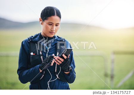 Music, phone and woman in the countryside ready for fitness and exercise with mockup. Sports, training and mobile headphones of a female athlete looking at gps with audio and web radio for workout 134175727