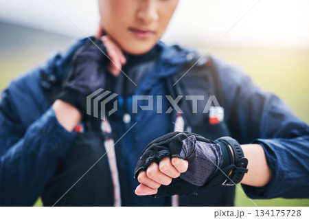 Pulse check, smart watch and woman hands in the countryside ready for fitness and exercise. Sports, training and runner time of a female athlete looking at workout app for health and wellness Pulse check, smart watch and woman hands in the countryside ready for fitness and exercise. Sports, training and runner time of a female athlete looking at workout app for health and wellness 134175728
