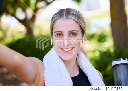 Portrait, happy woman or fitness influencer taking a selfie at training, running or workout in a park. Smile, runner or healthy girl athlete in headphones talking pictures or photo on social media Portrait, happy woman or fitness influencer taking a selfie at training, running or workout in a park. Smile, runner or healthy girl athlete in headphones talking pictures or photo on social media 134175754