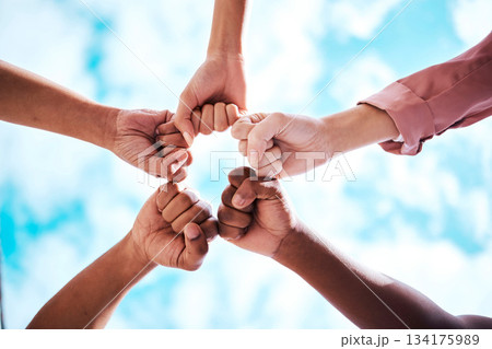 People, hands and fist bump in collaboration, trust or unity for partnership, community or diversity with sky below. Diverse group touching hands for teamwork, success or motivation in solidarity People, hands and fist bump in collaboration, trust or unity for partnership, community or diversity with sky below. Diverse group touching hands for teamwork, success or motivation in solidarity 134175989