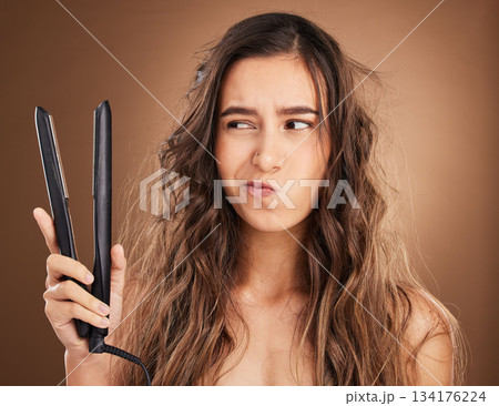 Hair care, flat iron and damage, portrait of woman on studio background, worried face and salon hairstyle. Haircare problem, electric straightener and frustrated latino model with spa heat treatment. Hair care, flat iron and damage, portrait of woman on studio background, worried face and salon hairstyle. Haircare problem, electric straightener and frustrated latino model with spa heat treatment. 134176224