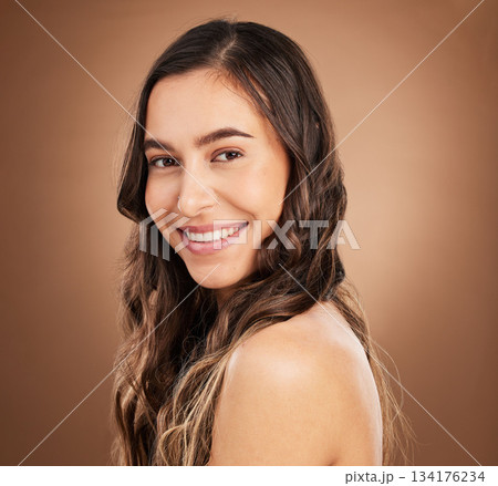 Beauty, portrait and woman in studio for hair, treatment and cosmetics against a brown background. Haircare, face and girl smile for natural, curly or wavy, texture or keratin, textures and confident Beauty, portrait and woman in studio for hair, treatment and cosmetics against a brown background. Haircare, face and girl smile for natural, curly or wavy, texture or keratin, textures and confident 134176234