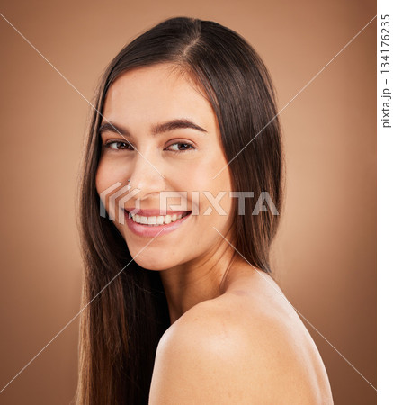 Hair, happy and portrait of woman in studio for wellness, keratin treatment and healthy style on brown background. Salon aesthetic, smile and face of girl with cosmetics, texture and natural beauty 134176235