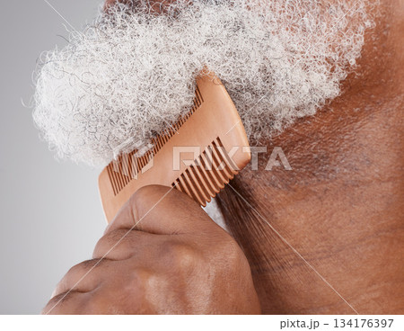 Man, hands and beard with comb in grooming, beauty or skincare hygiene against a studio background. Closeup of senior male neck and chin combing or brushing facial hair for clean wellness or haircare Man, hands and beard with comb in grooming, beauty or skincare hygiene against a studio background. Closeup of senior male neck and chin combing or brushing facial hair for clean wellness or haircare 134176397