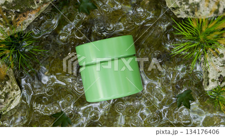 Green cream jar container mockup organic natural ingredient in water stream aside moss covered rock. 134176406