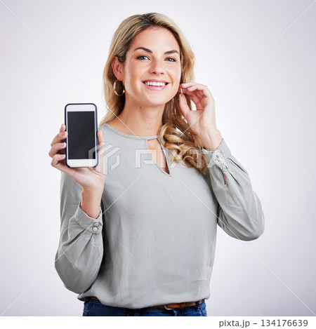 Happy woman, phone and mockup screen for advertising, marketing or app against a white studio background. Portrait of female smile showing mobile smartphone display for advertisement or copy space Happy woman, phone and mockup screen for advertising, marketing or app against a white studio background. Portrait of female smile showing mobile smartphone display for advertisement or copy space 134176639