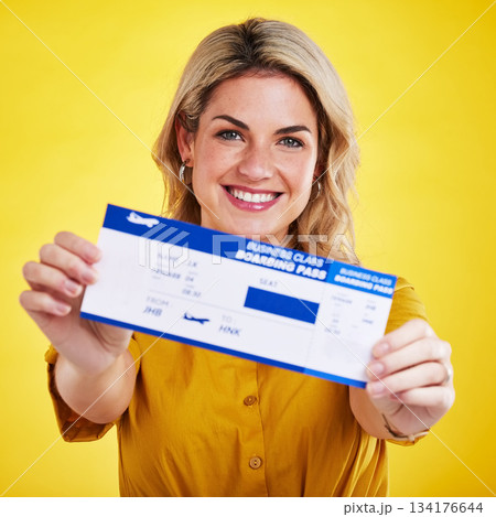Happy woman, plane ticket and portrait smile for travel, flight or vacation against a yellow studio background. Female traveler smiling with boarding pass, passport or permit for traveling or trip Happy woman, plane ticket and portrait smile for travel, flight or vacation against a yellow studio background. Female traveler smiling with boarding pass, passport or permit for traveling or trip 134176644