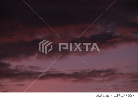 Dark ominous clouds filling dramatic purple twilight sky. Dark ominous clouds filling dramatic purple twilight sky. 134177657