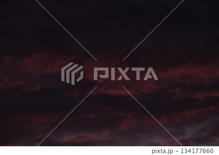 Dark red dramatic clouds background texture during deep twilight. Dark red dramatic clouds background texture during deep twilight. 134177660