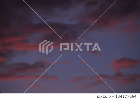 Dark sunset clouds coloring purple twilight sky drama. 134177664