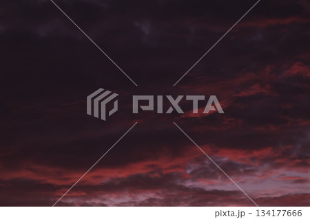 Dark ominous sky with dramatic red sunset clouds background. Dark ominous sky with dramatic red sunset clouds background. 134177666
