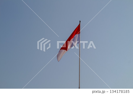 Indonesian National Flag Sang Saka Merah Putih waving proudly against clear blue sky 134178185