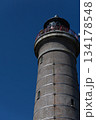 Tall Brick Lighthouse Tower Against Clear Deep Blue Sky Background 134178548