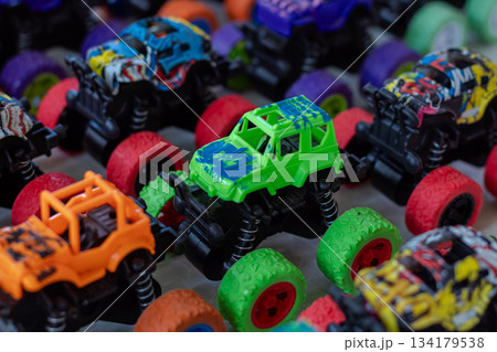 Close up view of bright colorful plastic monster trucks toys collection background for childrens playing fun 134179538