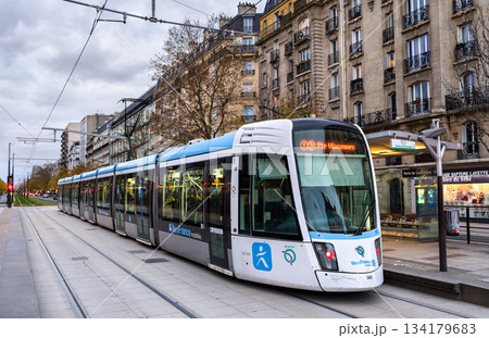 Paris, France - December 3, 2025: Alstom Citadis tram arrives at Porte de Saint-Ouen station. Modern T3b line vehicle connects the 17th and 18th arrondissements of Paris in Ile-de-France region Paris, France - December 3, 2025: Alstom Citadis tram arrives at Porte de Saint-Ouen station. Modern T3b line vehicle connects the 17th and 18th arrondissements of Paris in Ile-de-France region 134179683
