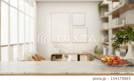 Apples on glass plate aside ceramic vase on marble counter table in white living room or modern cafe 134179865