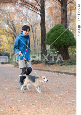 秋の公園で犬と散歩を楽しむ男性の笑顔とペットとの時間の全身 秋の公園で犬と散歩を楽しむ男性の笑顔とペットとの時間の全身 134179938