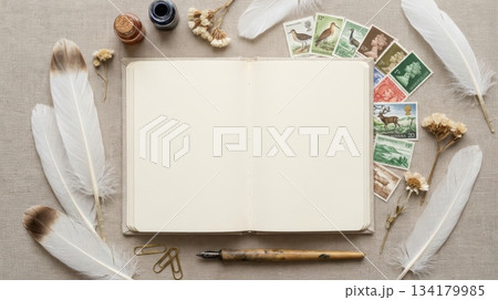 Notebook with Feathers and Vintage Stamp 134179985