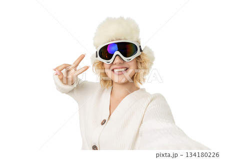 Person in winter gear gives a peace sign while smiling, isolated, PNG 134180226