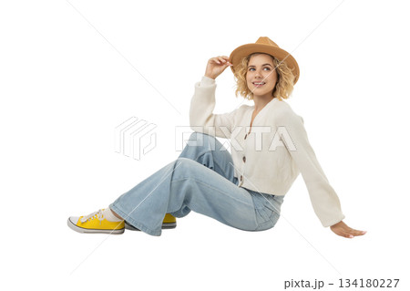 Young woman seated, exuding winter joy and style, isolated, PNG 134180227