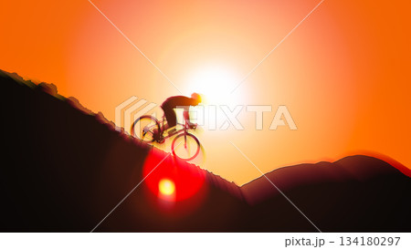 Silhouette of road cyclist riding bike uphill on mountain slope against orange sunset sky background with motion blur effect in summer 134180297