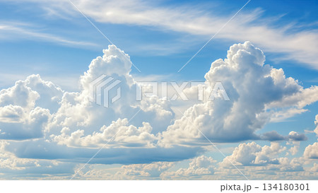 White fluffy cumulus clouds in bright blue sky background illustrating summer weather and heaven atmosphere concept with copy space area 134180301