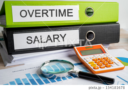 Overtime Salary. Binder data finance report business with graph analysis in office. Overtime Salary. Binder data finance report business with graph analysis in office. 134181678