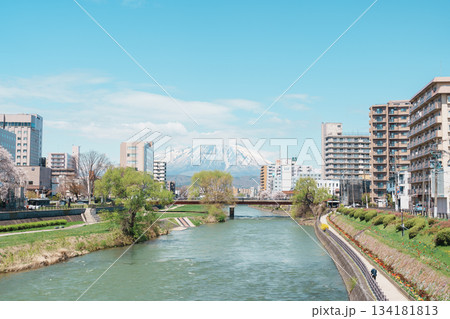Beautiful Iwate mountain and Kitakami river with flowers blooming in Spring season, cityscape against blue sky in Morioka city, Iwate prefecture, Japan. Iwate, Japan, 24 April 2025 Beautiful Iwate mountain and Kitakami river with flowers blooming in Spring season, cityscape against blue sky in Morioka city, Iwate prefecture, Japan. Iwate, Japan, 24 April 2025 134181813