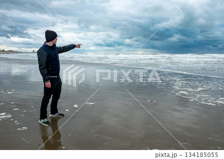 Seafarer indicates path, Navigator gestures towards turbulent Seafarer indicates path, Navigator gestures towards turbulent 134185055