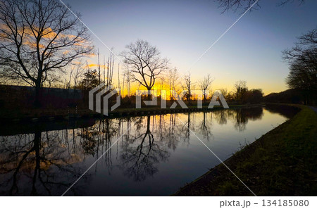 Breathtaking and Serene Sunset Reflections Over a Calm and Peaceful River During Evening 134185080