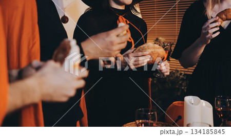 Friends enjoying a Halloween party at a bar making a toast Friends enjoying a Halloween party at a bar making a toast 134185845