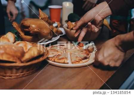 Festive Office Christmas Party with Delicious Food. A beautifully decorated office space with Christmas trees and festive lights, set up for a holiday party. 134185854