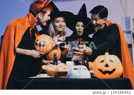 Friends enjoying a Halloween party at a bar making a toast 134186442